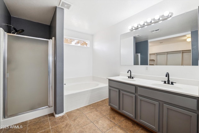 bathroom with a shower stall, visible vents, and a sink