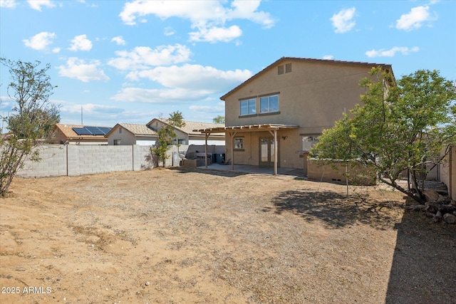 back of house with a patio, a fenced backyard, and stucco siding