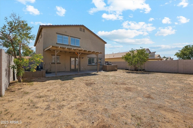 back of property featuring a patio area, stucco siding, and a fenced backyard
