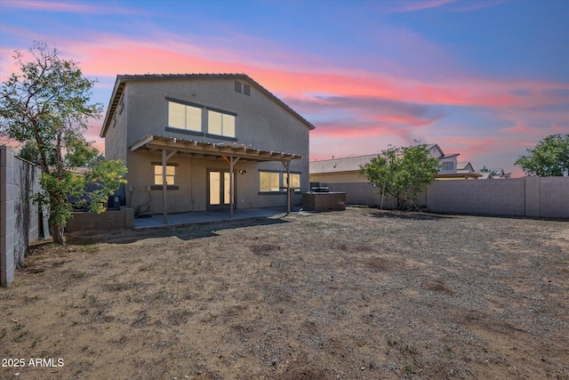 back of property featuring a fenced backyard, stucco siding, and a patio area