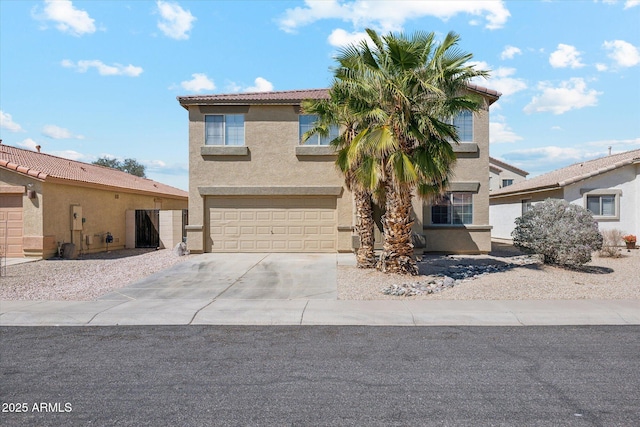 view of front of home with a tiled roof, a garage, stucco siding, and driveway