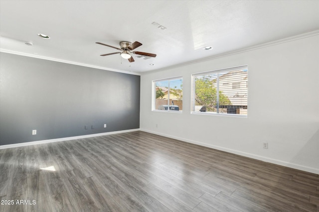 empty room featuring ornamental molding, baseboards, a ceiling fan, and wood finished floors