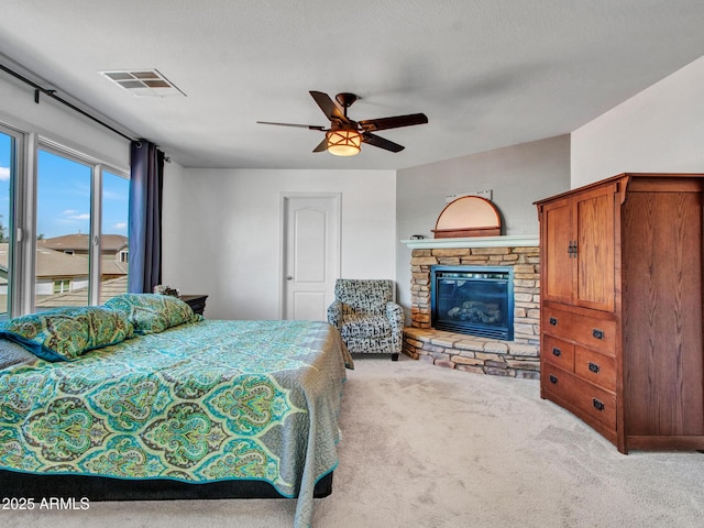16322 N 171st Dr, Surprise, AZ 85388 - bedroom featuring carpet floors, access to exterior, a stone fireplace, and ceiling fan