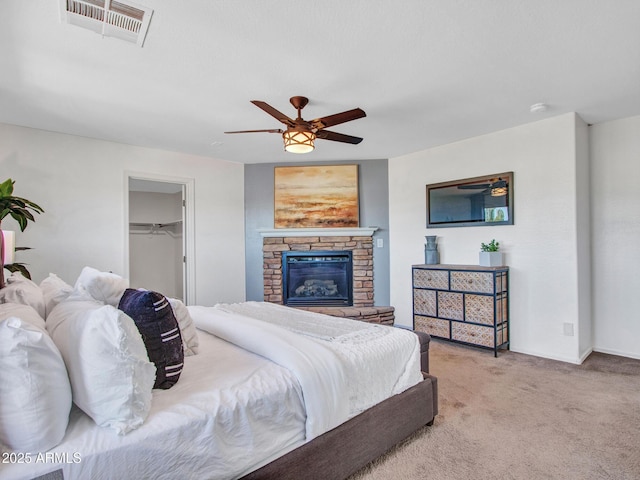 16322 N 171st Dr, Surprise, AZ 85388 - carpeted bedroom with a fireplace, ceiling fan, baseboards, and a spacious closet