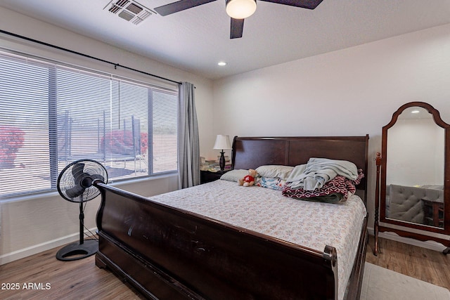 2714 E Valencia Dr, Phoenix, AZ 85042 - bedroom with baseboards, wood finished floors, ceiling fan, and recessed lighting