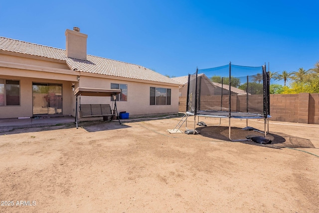 2714 E Valencia Dr, Phoenix, AZ 85042 - view of yard featuring a trampoline, fence, and a patio