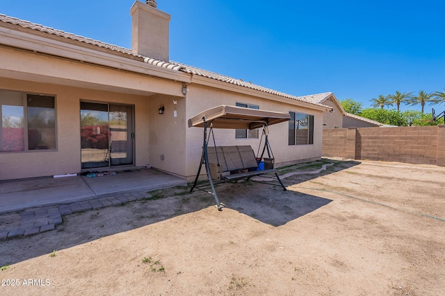 2714 E Valencia Dr, Phoenix, AZ 85042 - rear view of property with fence, a patio, a chimney, and stucco siding
