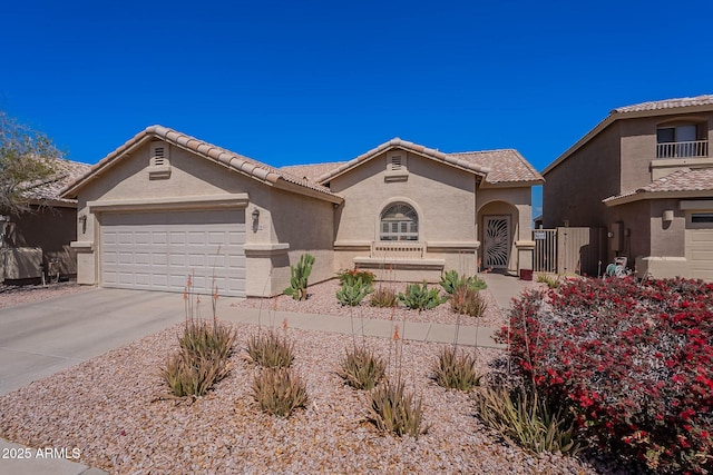 2714 E Valencia Dr, Phoenix, AZ 85042 - mediterranean / spanish-style house featuring stucco siding, concrete driveway, an attached garage, a tiled roof, and fence
