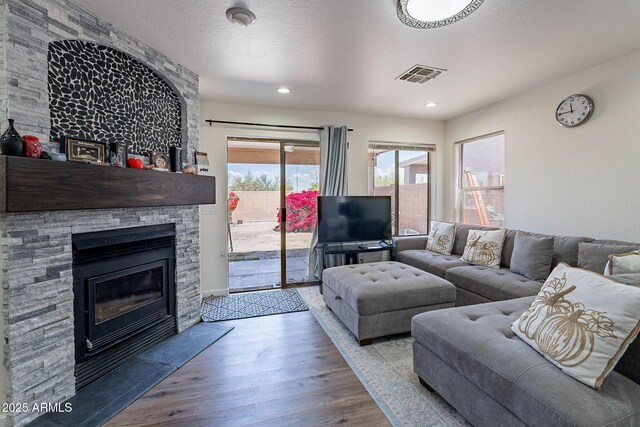 2714 E Valencia Dr, Phoenix, AZ 85042 - living room featuring wood finished floors, a fireplace, and recessed lighting