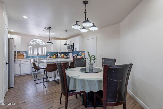 2714 E Valencia Dr, Phoenix, AZ 85042 - dining room featuring dark wood-style flooring, recessed lighting, and baseboards