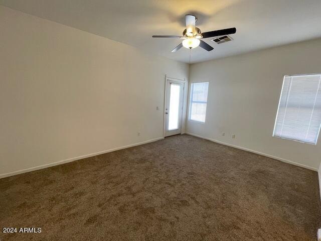 carpeted empty room featuring ceiling fan