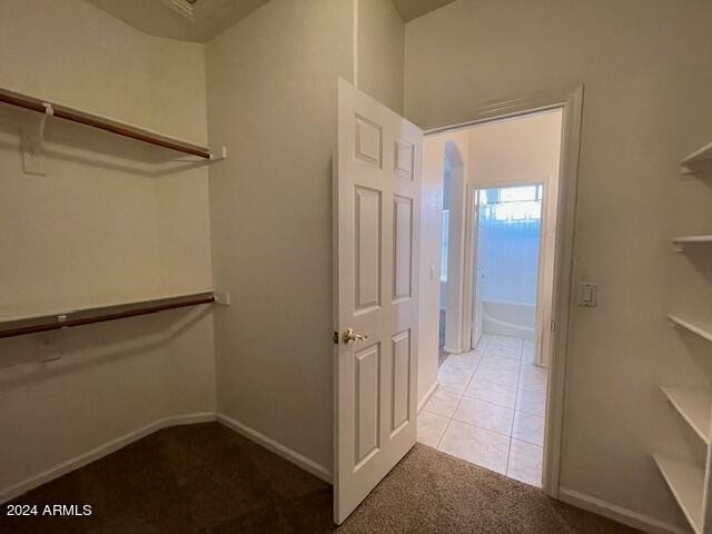 spacious closet with light tile patterned floors