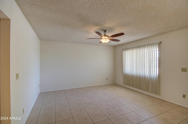 spare room featuring a textured ceiling and a ceiling fan