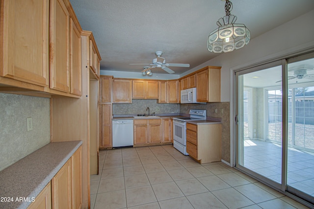 kitchen with pendant lighting, sink, white appliances, light tile patterned flooring, and light brown cabinetry