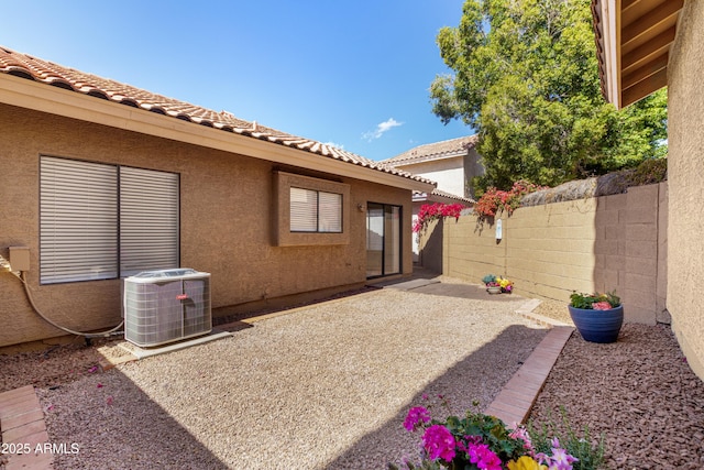 view of patio / terrace featuring fence and central AC unit