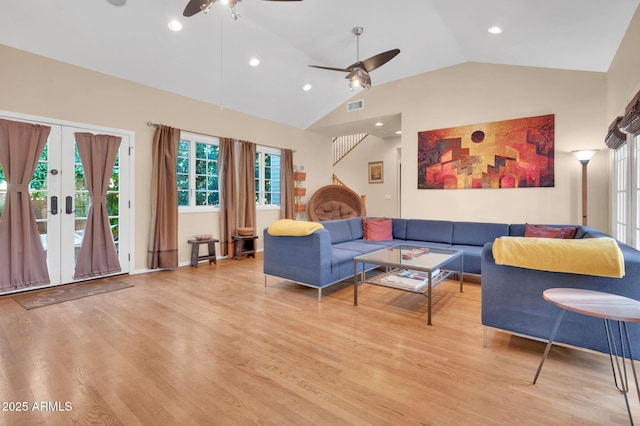 living room featuring ceiling fan, high vaulted ceiling, light wood-type flooring, and french doors