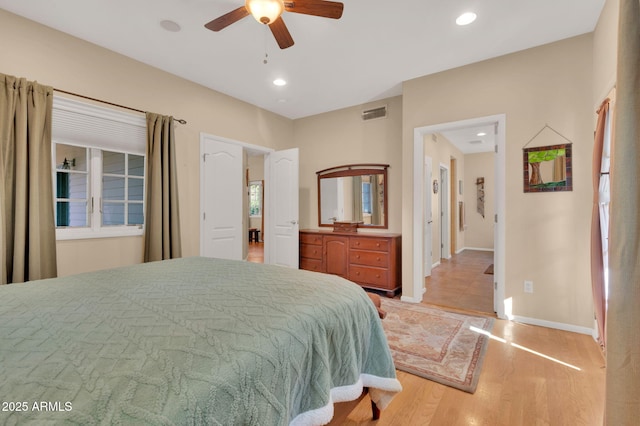 bedroom with ceiling fan and light wood-type flooring