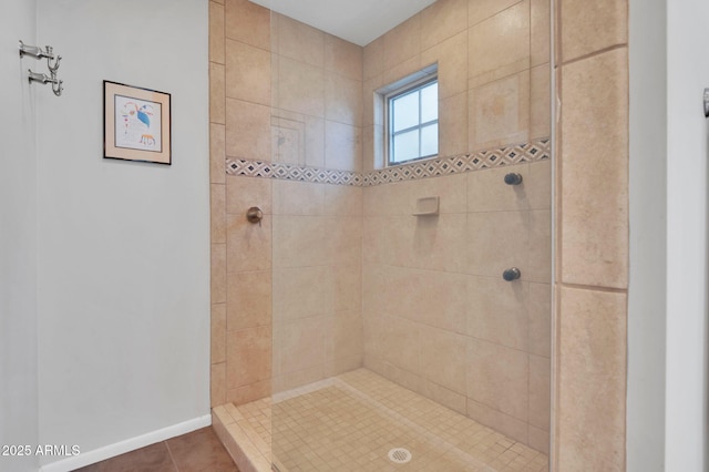 bathroom with tile patterned floors and tiled shower