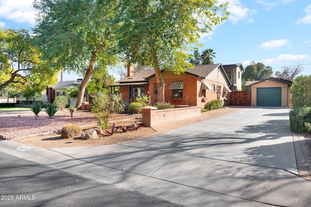 view of front of property with a garage and an outdoor structure