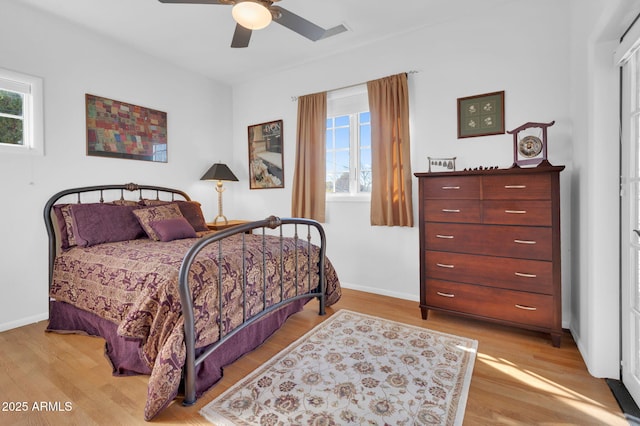 bedroom with ceiling fan and light hardwood / wood-style floors