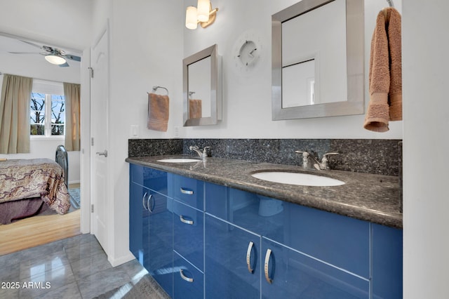 bathroom with tile patterned flooring, vanity, and ceiling fan