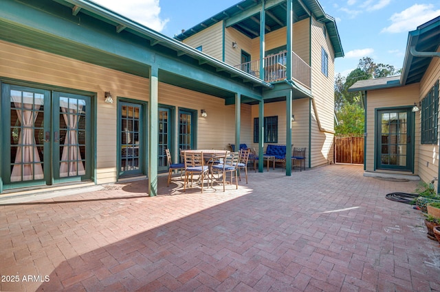 view of patio / terrace featuring a balcony and french doors