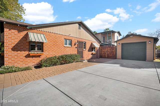 view of front of home with a garage and an outdoor structure