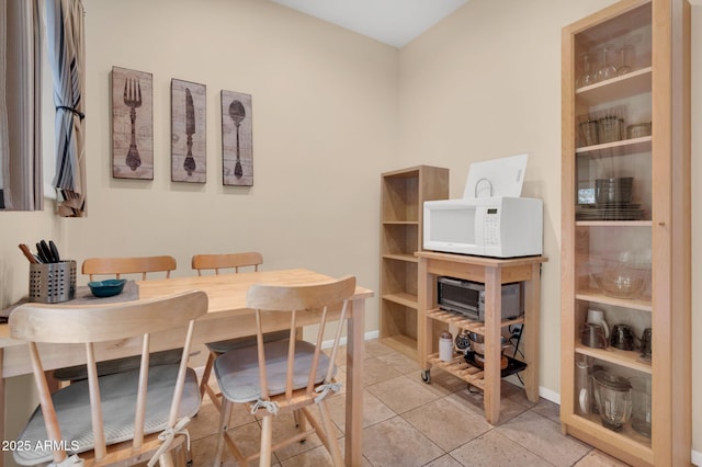 dining space featuring light tile patterned floors