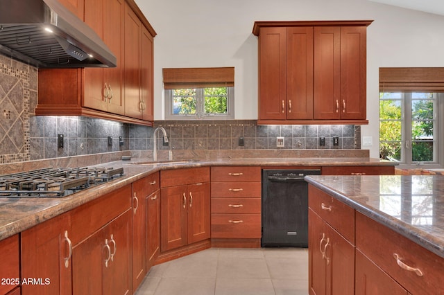 kitchen featuring sink, backsplash, stainless steel gas cooktop, exhaust hood, and light stone countertops