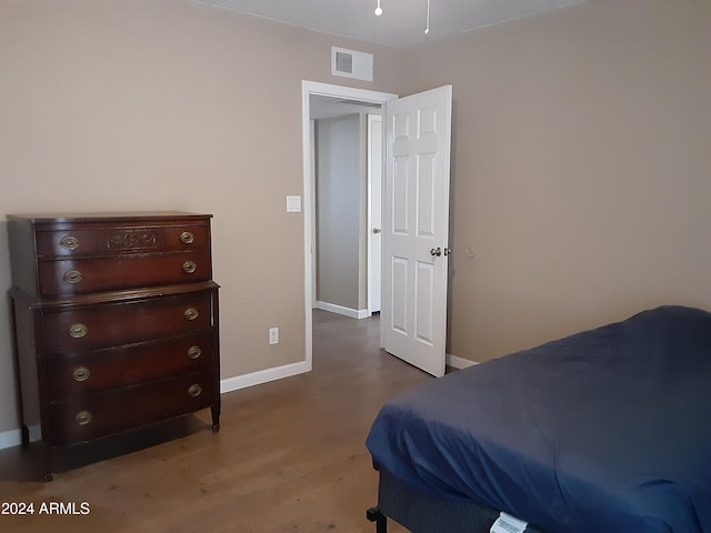 bedroom with hardwood / wood-style flooring