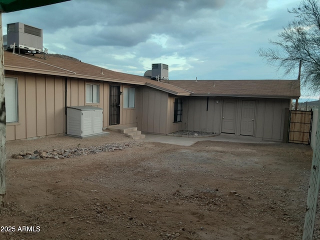 rear view of property with central AC unit