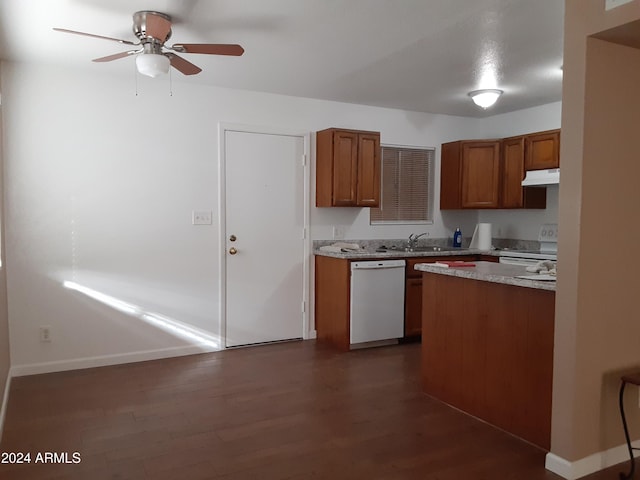 kitchen featuring dark wood-type flooring, white appliances, ceiling fan, and sink