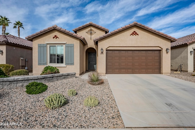 mediterranean / spanish-style home with a garage