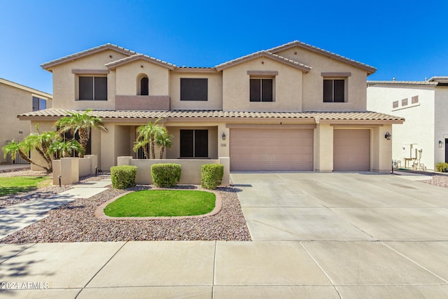 mediterranean / spanish-style house with a garage