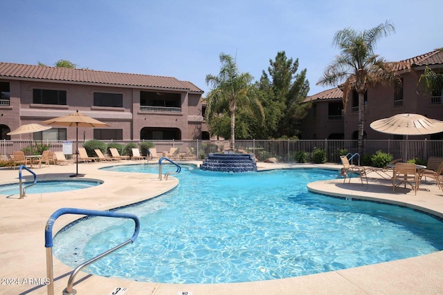 view of pool with a community hot tub and a patio