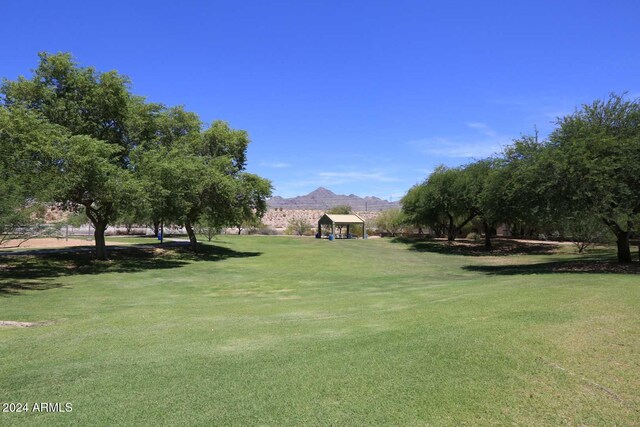 surrounding community featuring a gazebo, a mountain view, and a lawn