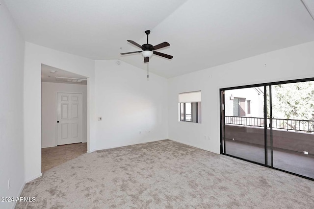 carpeted spare room with ceiling fan and lofted ceiling