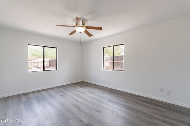 empty room with ceiling fan and wood-type flooring