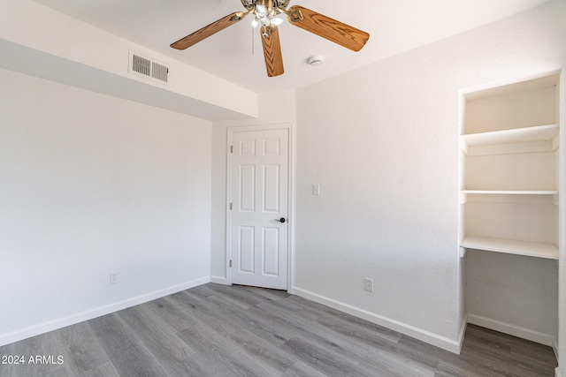 unfurnished bedroom featuring ceiling fan, a closet, and light hardwood / wood-style flooring