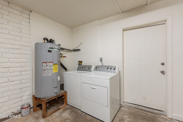 laundry area with separate washer and dryer, brick wall, and water heater