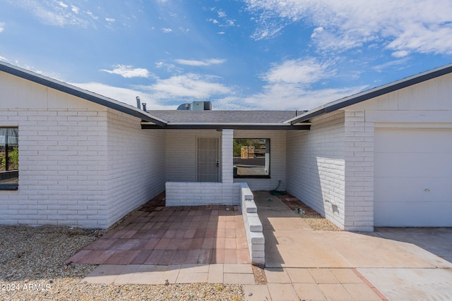 doorway to property with a garage