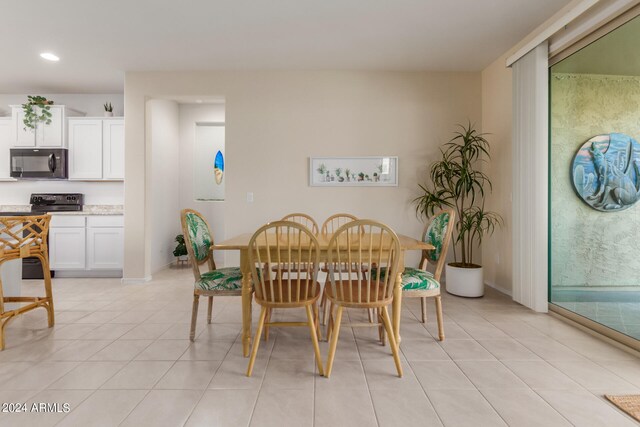 dining space featuring light tile patterned flooring