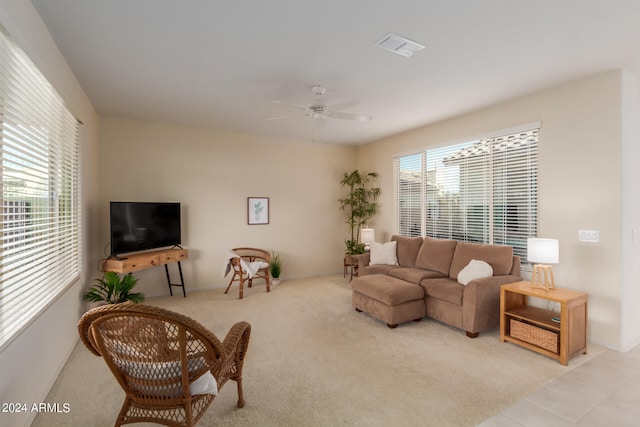 carpeted living room featuring ceiling fan