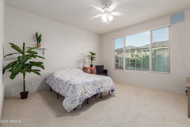 bedroom with ceiling fan and light carpet