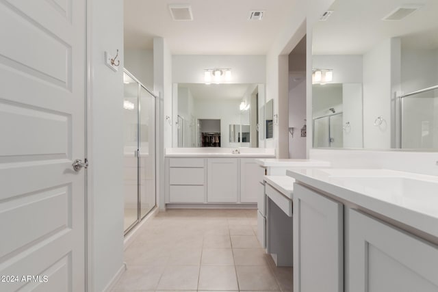 bathroom with vanity, walk in shower, and tile patterned flooring