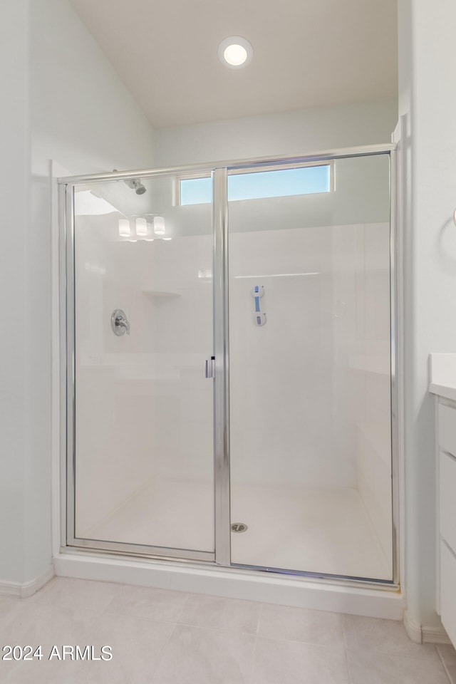 bathroom featuring vanity, tile patterned floors, and an enclosed shower