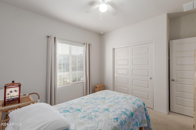 carpeted bedroom with a closet and ceiling fan