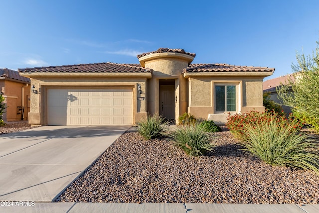 7790 W Noble Prairie Way, Florence, AZ 85132 - mediterranean / spanish home with stucco siding, an attached garage, driveway, and a tiled roof