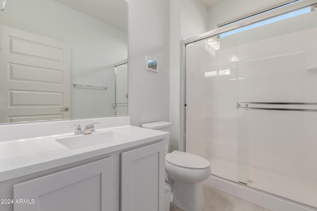 bathroom with vanity, toilet, walk in shower, and tile patterned flooring