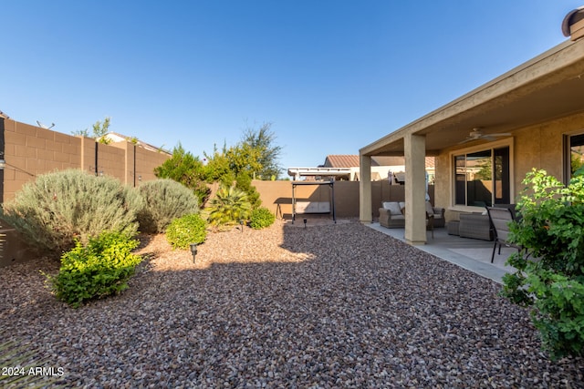 view of yard with ceiling fan, a patio area, and outdoor lounge area